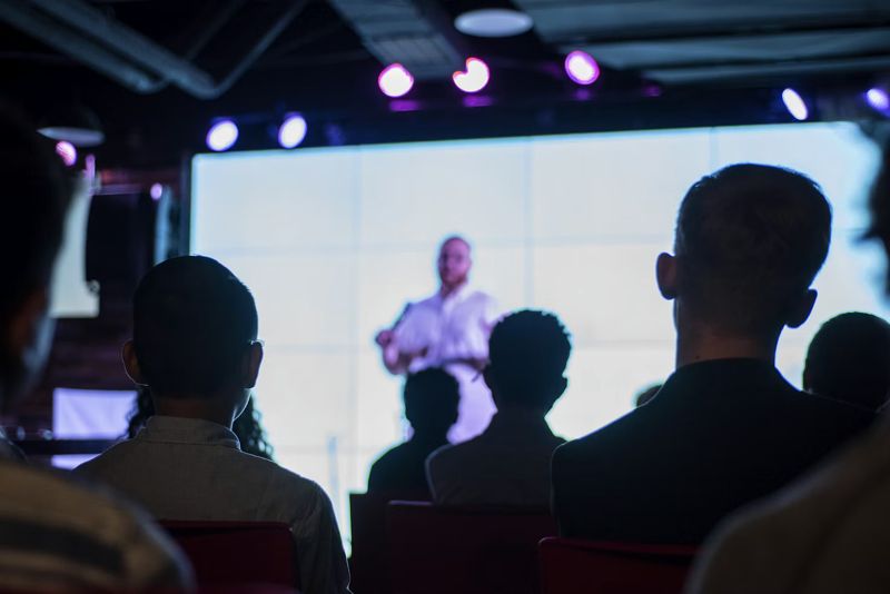 An audience watching a presenter at a training session